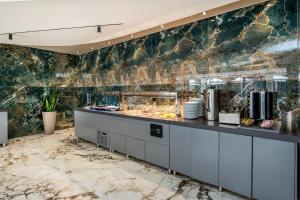 a buffet in a restaurant with a stone wall at Green Bay in Limenaria