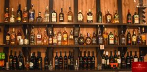 a bunch of bottles of alcohol on shelves at Hotel Montenegro in Struga +8 photos