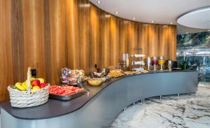 a buffet in a hotel with fruit on a counter at Green Bay in Limenaria