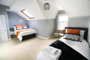 a bedroom with two beds in a attic at K Suites - Laurell Ville in Amley