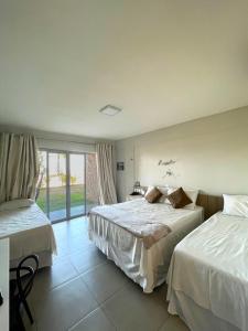 Habitación de hotel con 2 camas y ventana en Locanda dei Venti en Itarema
