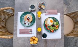 a table with two plates of food and a plate of food at Green Bay in Limenaria