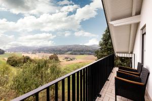 a balcony with chairs and a view of the mountains at Monis Appartementhaus in Unterlamm