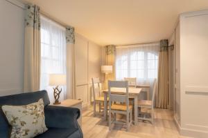 a living room with a table and a dining room at The Glencoe Inn in Glencoe