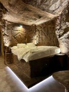 a bed in a stone room in a cave at Apartmány v Podzámčí v blízkosti zámku Blatná in Blatná