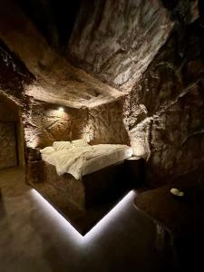 a bedroom with a bed in a stone cave at Apartmány v Podzámčí v blízkosti zámku Blatná in Blatná