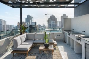 a living room with a couch on a balcony at The Tokyo 307 in Cape Town