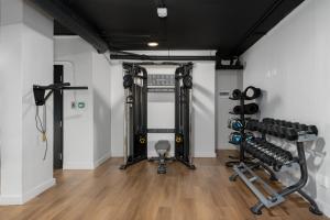 a gym with two treadmills and weights at The Tokyo 307 in Cape Town