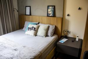 a bedroom with a bed with pillows on it at Studio no centro de Curitiba in Curitiba +26 photos