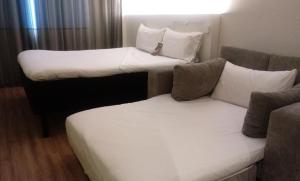 a room with two beds and a couch at ibis Styles Sao Paulo Barra Funda in Sao Paulo