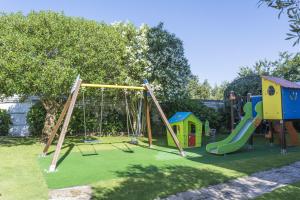 a playground with a slide and a swing set at Hotel Nuevo Vichona Spa 3 estrellas Superior in Sanxenxo
