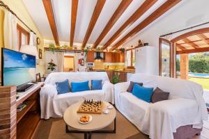 a living room with two white couches and a chessboard at Villa Llompart Pollensa by JS Villas in Pollença