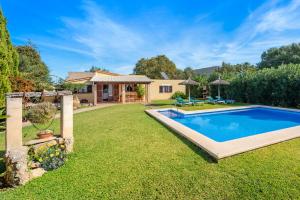 a backyard with a pool and a house at Villa Llompart Pollensa by JS Villas in Pollença