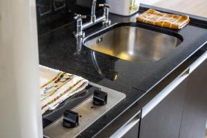 a kitchen with a sink and a counter at Studio no centro de Curitiba in Curitiba
