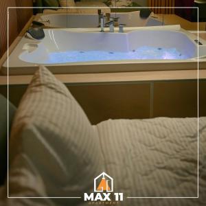 A bed or beds in a room at MAX 11 Apartman