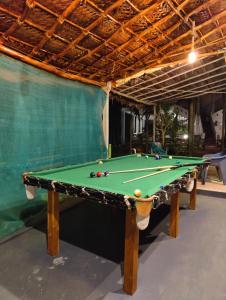 a pool table with balls on it in a room at ArtKarna in Gokarna