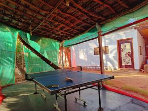 a ping pong table in the middle of a room at ArtKarna in Gokarna