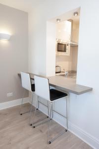 a kitchen with a white counter top and white cabinets at Temple Bar Essex Street Apartments in Dublin