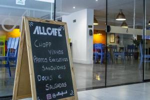 a chalkboard sign in front of a restaurant at Studio no centro de Curitiba in Curitiba