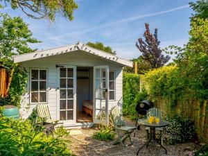 a small shed in a garden with a table and chairs at 2 bed in Oulton 88109 in Lowestoft