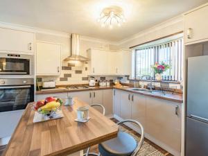 a kitchen with a table with a bowl of fruit on it at 2 bed in Mablethorpe 87801 in Mablethorpe