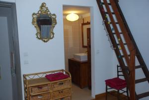 a bathroom with a staircase leading to a bathroom with a mirror at Chambre la case lé la in Salses-le-Chateau