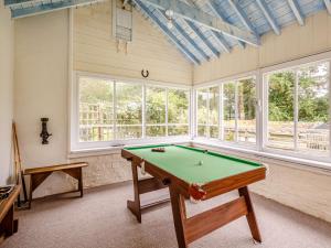 a pool table in a room with windows at 3 Bed in Bala 88351 in Frongoch