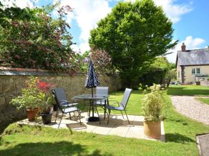 a patio with a table and chairs in a yard at 1 bed in Barnstaple 88259 
