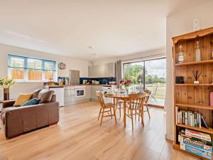 a kitchen and living room with a couch and a table at 2 bed in Minety 89025 in Minety