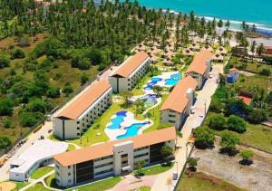 an aerial view of a resort with a water park at Lindo Flat no Carneiros Beach Resort in Tamandaré