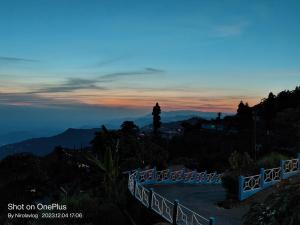 a view of the sunset from the top of a mountain at RKD HOMESTAY in Kurseong