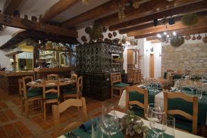 a restaurant with tables and chairs in a room at Apartmán-Hotel Jítravský Dvorec in Rynoltice