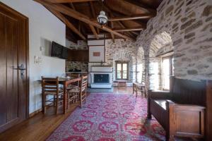 a living room with a kitchen and a dining room at Archontiko Michael Pelion in Vyzitsa