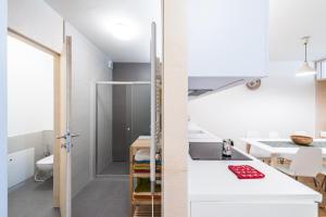 a small kitchen with white counters and a sink at Castle Wall Apartment in Bratislava +12 photos