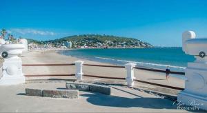 a person walking on a beach near the water at Villa Anita Spa in Piriápolis
