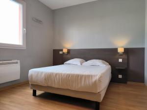 a bedroom with a large bed with two pillows at City Résidence Marseille in Marseille +6 photos