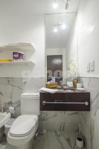 a white bathroom with a toilet and a sink at Cozy Loft, Few Meters From Mariscal Lopez in Asunción