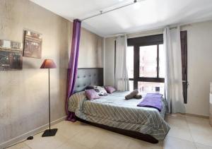 a bedroom with a bed with purple curtains and a window at LOVE ISLAND 77 in Palm-mar +12 photos