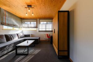 a living room with a couch and a table at Voevodyno Resort in Turʼya Paseka