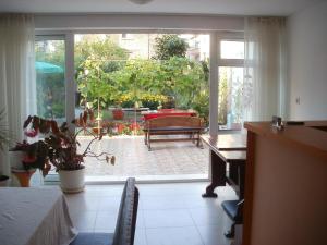 a room with a door open to a patio with a table at Veda Guest House in Pomorie