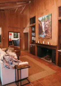a living room with a couch and a fireplace at Hidden Valley Wilderness Lodge in San Ignacio