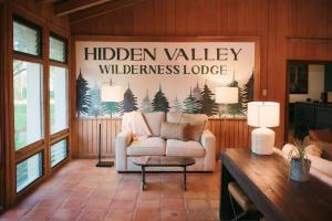 a living room with a white couch and a table at Hidden Valley Wilderness Lodge in San Ignacio