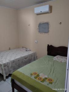 een slaapkamer met 2 bedden en verwarming aan de muur bij Aconchego do bens in Cruz