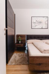 a bedroom with a bed and a white wall at 10 minutes to the center, 2 minutes to the metro in Vienna