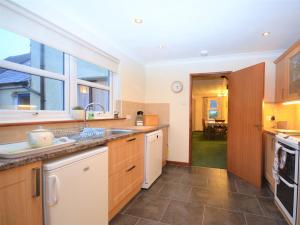a large kitchen with a sink and a window at 3 bed in Fishguard 37270 in Fishguard