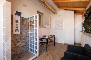 a room with a table and a stone wall at Over The Top - Lu Sule in Copertino