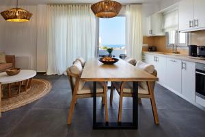 a kitchen and dining room with a table and chairs at EPICENTER LUXURY RESIDENCE in Mesaria