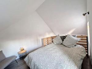a bedroom with a bed with pillows on it at Studio Duplex Calme-Parking-Wifi in Comps-la-Grand-Ville