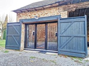 a pair of blue doors in front of a brick building at Studio Duplex Calme-Parking-Wifi in Comps-la-Grand-Ville