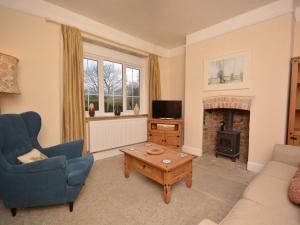 a living room with a couch and a fireplace at 2 bed property in Ilminster Somerset 56523 in Ilminster